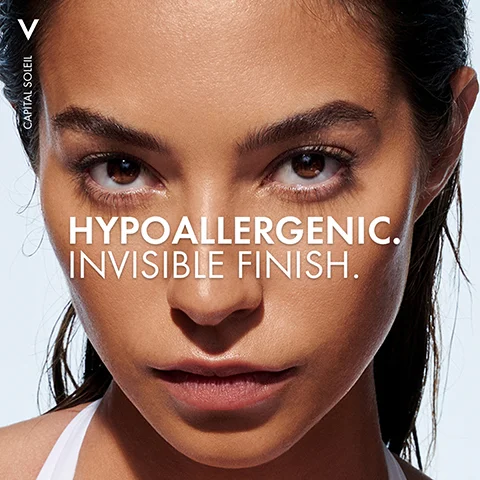 Image 1 - A close-up of a woman’s face with a neutral expression featuring the text HYPOALLERGENIC. INVISIBLE FINISH. in bold white letters.