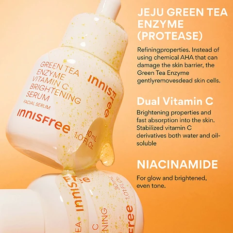 Image 4 - Two clear dropper bottles of innisfree Green Tea Enzyme Vitamin C Brightening Serum, one tilted with a drop of serum containing yellow particles, are shown against an orange background with product information that reads: GREEN TEA ENZYME VITAMIN C BRIGHTENING SERUM FACIAL SERUM innisfree 30 mL 1.01 Fl. Oz. JEJU GREEN TEA ENZYME (PROTEASE) Refining properties. Instead of using chemical AHA that can damage the skin barrier, the Green Tea Enzyme gently removes dead skin cells. Dual Vitamin C Brightening properties and fast absorption into the skin. Stabilized vitamin C derivatives both water and oil-soluble. NIACINAMIDE For glow and brightened, even tone. Image 5 - A split image of a womans face, with the left side showing her natural bare face and the right side showing her instantly brighter complexion after treatment, with text reading BEFORE, INSTANTLY AFTER, Bare Face, and Visibly Brighter Complexion. Image 6 - A white dropper bottle for Innisfree Green Tea Enzyme Vitamin C Brightening Facial Serum is nestled in a grapefruit peel, alongside text that reads YOUR DAILY SHOT OF VITA C, with bullet points stating 93% felt that their pores are cleaned up after using the product*, 83% felt that dull, dead skin looks cleaned using the product*, and 83% felt that their skin is less oily using the product*, followed by *Based on a 14-day independent consumer study on 30 women aged 20-35. The bottle itself displays GREEN TEA ENZYME VITAMIN C BRIGHTENING SERUM FACIAL SERUM innisfree 30 mL 1.01 FL. OZ. Image 7 - A hand holds a dropper with golden serum dripping into an open white Innisfree bottle, with visible text including KOREAN BRIGHTENING SERUM, Green Tea Extract to help soothe and brighten, Wont clog pores + Safe for acne prone skin, Liquid gel texture melts into skin, Dermatologically tested, and on the bottle: GREEN TEA ENZYME VITAMIN C BRIGHTENING SERUM FACIAL SERUM Innisfree 30 mL 1.01 FL.OZ., innisfree, and free. Image 8 - A close-up of a person with light-colored hair and an orange background applying serum to their face with a dropper, holding a bottle of Innisfree Green Tea Enzyme Vitamin C Brightening Serum, with text overlaid that reads WHO IS THIS GOOD FOR? followed by three boxes with checkmarks reading Dark Spots + Sun Spots, Uneven texture, and Dullness.