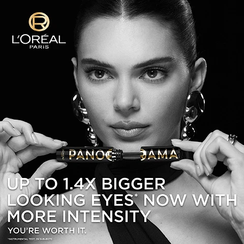 Image 1 - A woman with long dark hair and bold makeup is holding a mascara tube in front of her face, with oversized earrings and a black top, accompanied by the text UP TO 1.4X BIGGER LOOKING EYES* NOW WITH MORE INTENSITY YOURE WORTH IT. The logo for LOréal Paris is in the top left corner.
Image 2 - A close-up of a black mascara tube labeled PANORAMA with gold accents, featuring the text LONG WEAR POLYMER INFUSED FORMULA, UP TO 24H WEAR, and INFUSED WITH ULTRA BLACK PIGMENTS.
Image 3 - A close-up of a woman with sleek hair and bold gold earrings, looking slightly upwards, accompanied by text that reads: CORNER-TO-CORNER PANORAMIC VOLUME, UP TO 24H WEAR*, FANDED OUT LASHES, CLUMP FREE, SMUDGE RESISTANT.
Image 4 - Image shows a side-by-side comparison of a womans eye before and after applying mascara, with the left labeled as BEFORE and the right as AFTER; above the images, there is text that reads FOR ALL LASH TYPES, UP TO 1.4X BIGGER-LOOKING EYES*, UP TO 24H WEAR**.
Image 5 - A mascara wand is shown above a rippling surface, with text stating ENRICHED WITH 5% STRETCHFLEX COMPLEX, ULTRA FLEXIBLE FORMULA, and WRAPS EACH LASH FOR PERFECTLY SEPARATED, CLUMP FREE VOLUME.
Image 6 - Image shows two mascara products labeled Panorama All Night Black and Panorama Classic, with the All Night Black product featuring a mascara wand; visible text includes UP TO 24H BLACK INTENSITY FOR ALL NIGHT LONG and UP TO 1.4X BIGGER LOOKING EYES.
Image 7 - Image shows a close-up of a black multi-level bristle brush for makeup application with short and long bristles designed to volumise and fan the lashes, along with the text: MULTI-LEVEL BRISTLE BRUSH, SHORT & LONG BRISTLES TO VOLUMISE & FAN THE LASHES.
Image 8 - A close-up of a woman applying mascara, with text stating TESTED UNDER OPHTHALMOLOGICAL CONTROL, SUITABLE FOR SENSITIVE EYES, and SUITABLE FOR CONTACT LENS WEARERS.
Image 9 - Image shows a promotional graphic for LOréal Paris cosmetics featuring a black mascara tube labeled Panorama All Night Black and a gold eyeliner pencil labeled Bronze Blaze, with the text Get bigger & more intense looking eyes.