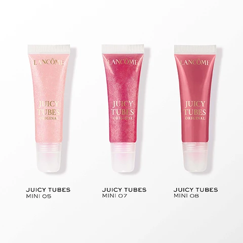 Image 2 - Three sparkling lip gloss tubes are shown, from left to right, they are light pink, fuchsia, and red-orange, each labeled Lancôme Juicy Tubes Original, with additional text below reading Juicy Tubes Mini 05, Juicy Tubes Mini 07, and Juicy Tubes Mini 08. Image 3 - A four-panel image features a close-up of glossy pink lips with a lip gloss tube partially visible showing text ICY BES NAL, a shimmery rose-pink swatch with text MAGIC SPELL, a shimmery light pink swatch with text MARSHMALLOW ELECTRO, and a smooth deep rose-pink swatch with text TICKLED PINK. Image 4 - The image shows a four-step lip makeup tutorial: Step 1 displays a person outlining their glossy lips with a brown lip liner, with text STEP 1 OUTLINE YOUR LIPS WITH LIP IDÔLE LIP SHAPER; Step 2 shows the lined lips, with text STEP 2 BLEND THE LINER INWARD WITH YOUR FINGER; Step 3 illustrates a light pink shimmery lip gloss being applied, with text STEP 3 APPLY YOUR FAVOURITE JUICY TUBES; and Step 4 presents the finished glossy lips, with text STEP 4 AFTER. Image 5 - An advertisement for Lancôme lip glosses features an open Juicytreat Oil-in-Gloss with a dripping wand, two closed glosses, and a pink Juicy Tubes Original lip gloss tube against a backdrop of pink clouds and snow-capped mountains, resting on a pink box decorated with snowflakes and Roman numerals, with visible text reading Shop The Collection, New Juicytreat Oil-in-Gloss, Lancôme, Juicy Tubes High Shine Gloss, and Juicy Tubes Original.